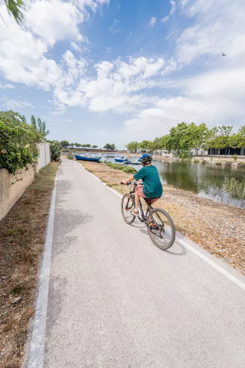 Child riding a bicycle on a greenway